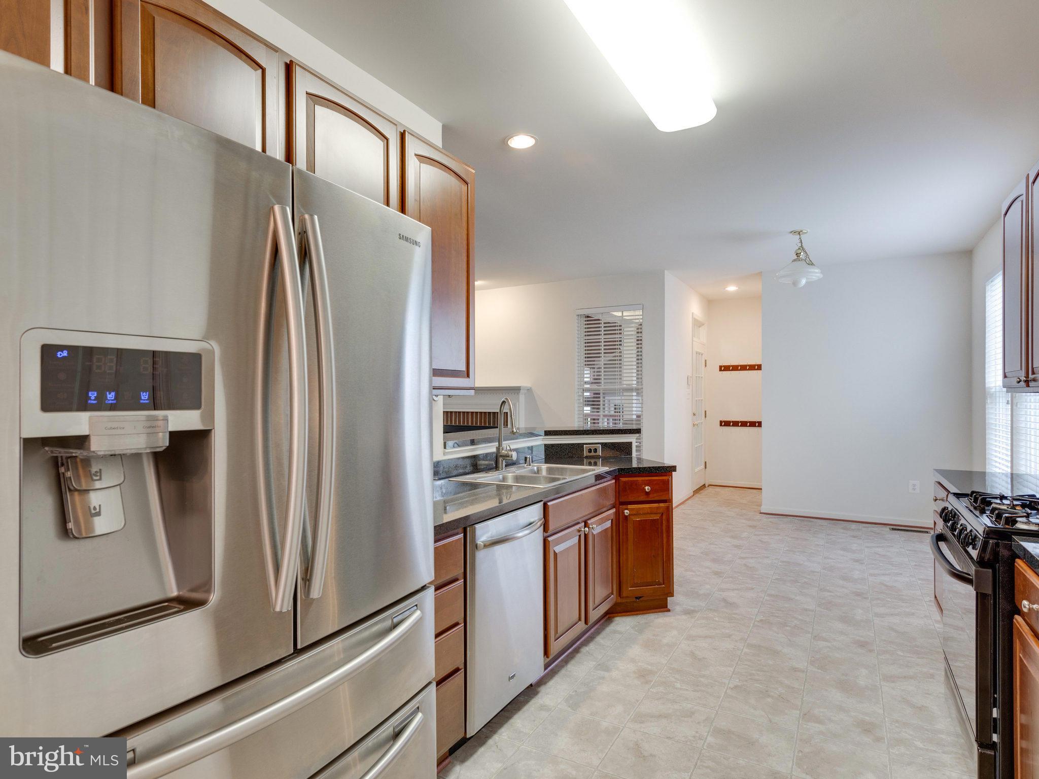 18411 Thundercloud Road Boyds, MD 20841 - Photo 6 of 30 a kitchen with stainless steel appliances granite countertop a refrigerator and a stove