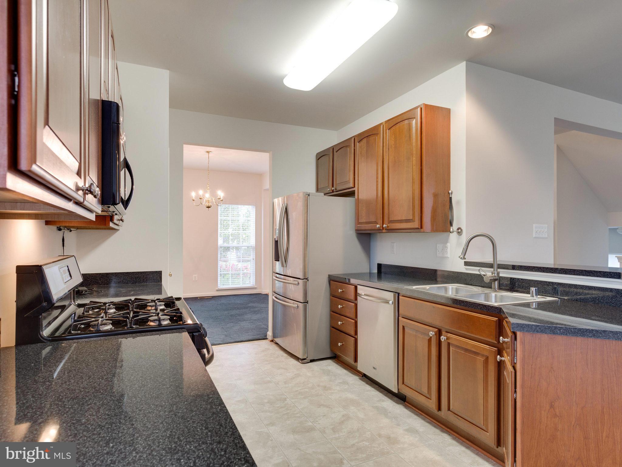 18411 Thundercloud Road Boyds, MD 20841 - Photo 7 of 30 a kitchen with stainless steel appliances granite countertop a stove a sink dishwasher and a refrigerator