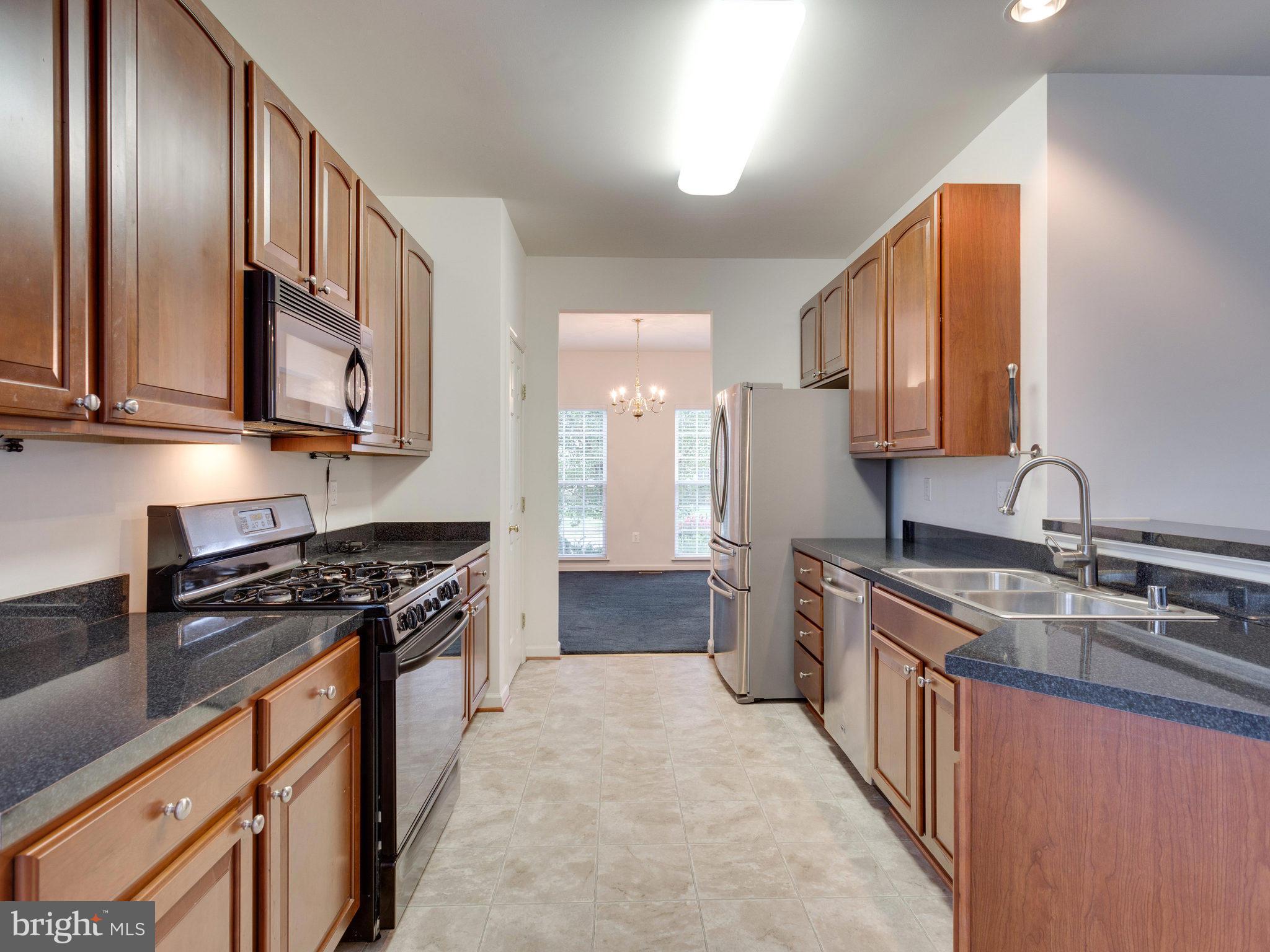 18411 Thundercloud Road Boyds, MD 20841 - Photo 8 of 30 a kitchen with stainless steel appliances granite countertop a stove a sink dishwasher and a refrigerator