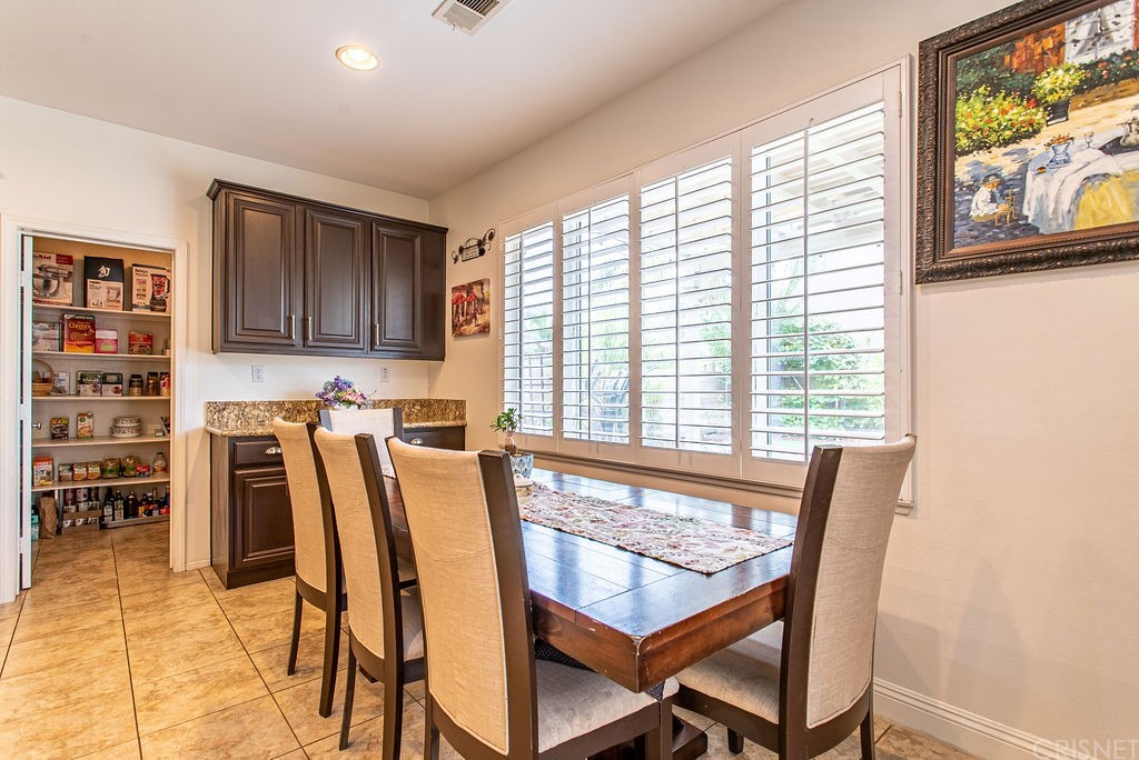 25054 Oliver Way Stevenson Ranch, CA 91381 - Photo 15 of 53 a view of a dining room with furniture and a floor to ceiling window