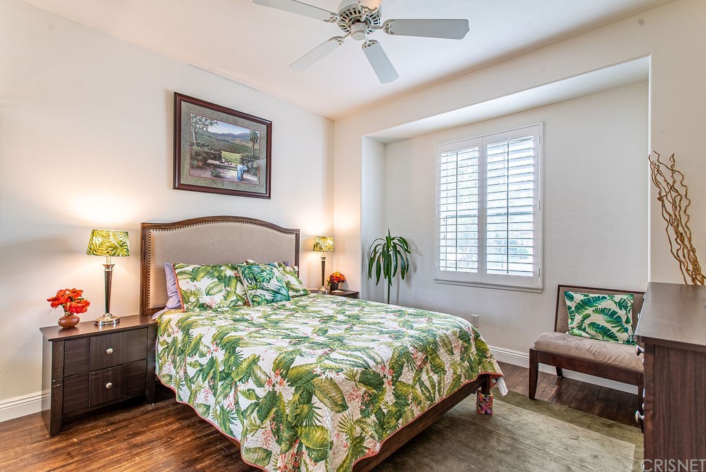 25054 Oliver Way Stevenson Ranch, CA 91381 - Photo 21 of 53 a bedroom with a bed and a chandelier