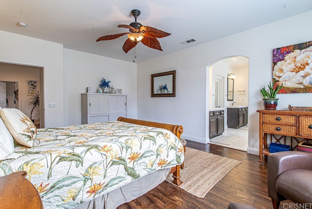 25054 Oliver Way Stevenson Ranch, CA 91381 - Photo 27 of 53 a bedroom with a bed and wooden floor