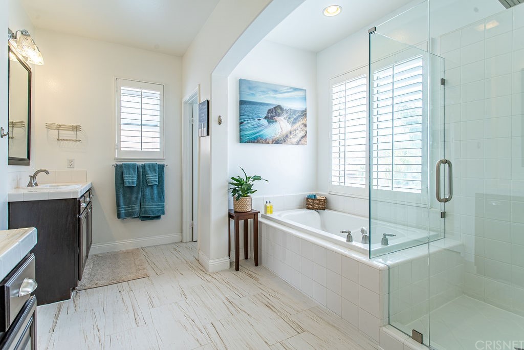 25054 Oliver Way Stevenson Ranch, CA 91381 - Photo 28 of 53 a bathroom with a tub a potted plant and a sink