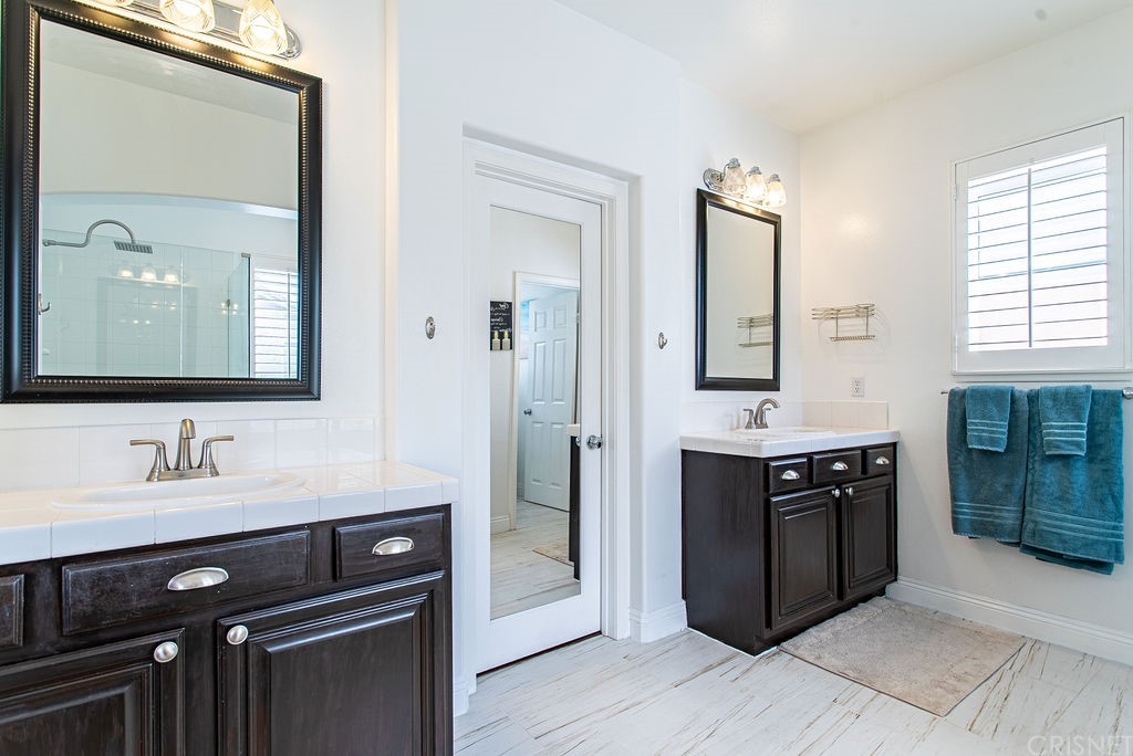 25054 Oliver Way Stevenson Ranch, CA 91381 - Photo 29 of 53 a kitchen with a sink stove and cabinets