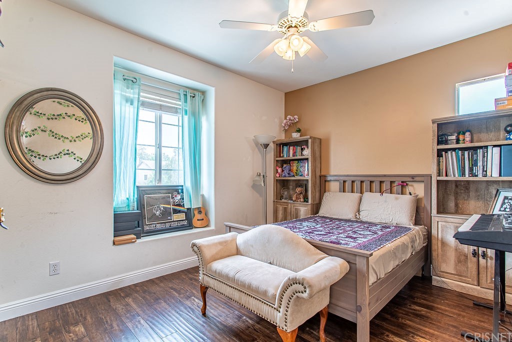 25054 Oliver Way Stevenson Ranch, CA 91381 - Photo 31 of 53 a bedroom with a bed bookshelf and a window