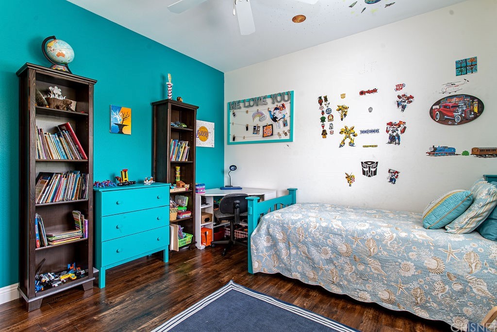 25054 Oliver Way Stevenson Ranch, CA 91381 - Photo 34 of 53 a bedroom with a bed and a bookshelf