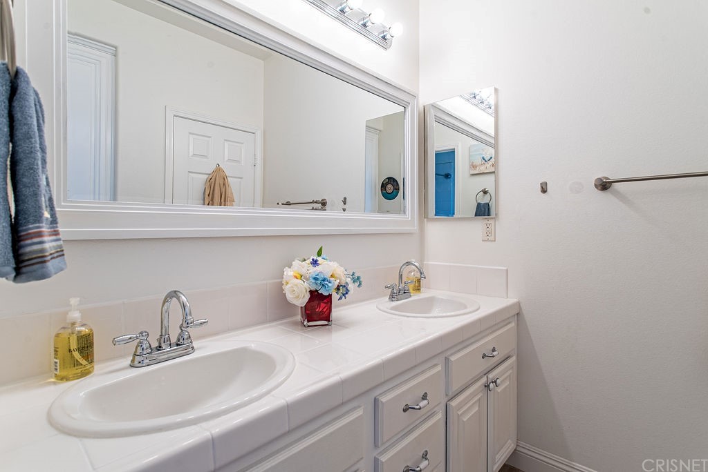 25054 Oliver Way Stevenson Ranch, CA 91381 - Photo 35 of 53 a bathroom with a sink and a mirror