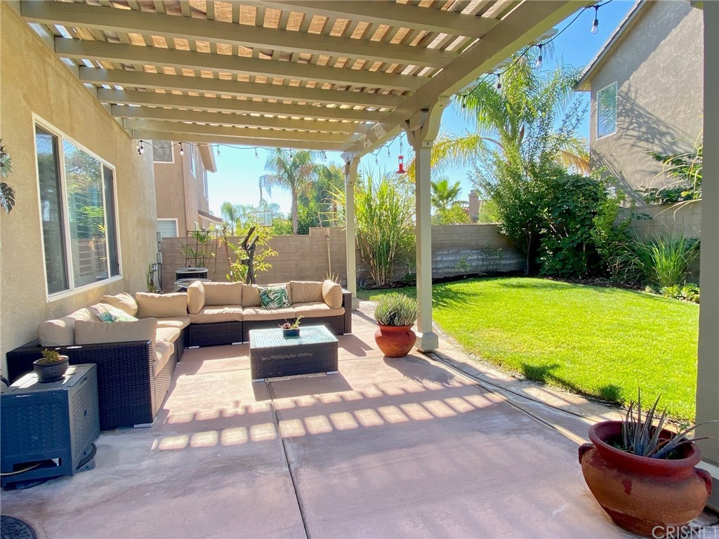 25054 Oliver Way Stevenson Ranch, CA 91381 - Photo 38 of 53 a living room with furniture and a swimming pool