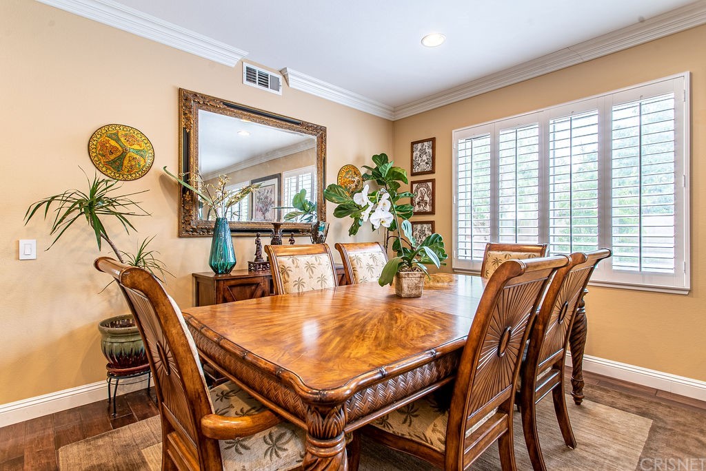 25054 Oliver Way Stevenson Ranch, CA 91381 - Photo 7 of 53 a dining room with furniture and wooden floor