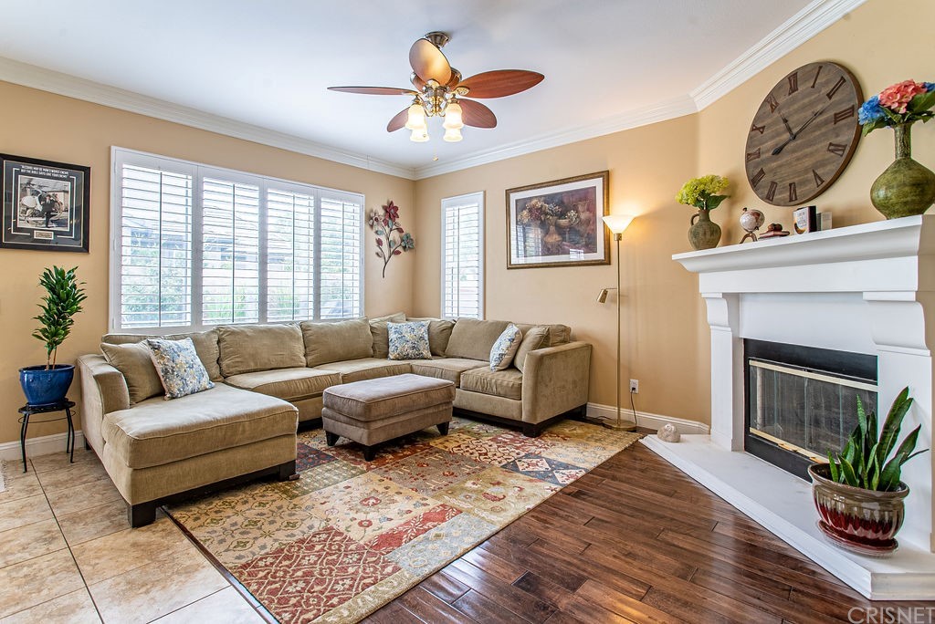 25054 Oliver Way Stevenson Ranch, CA 91381 - Photo 9 of 53 a living room with furniture a chandelier and a fireplace