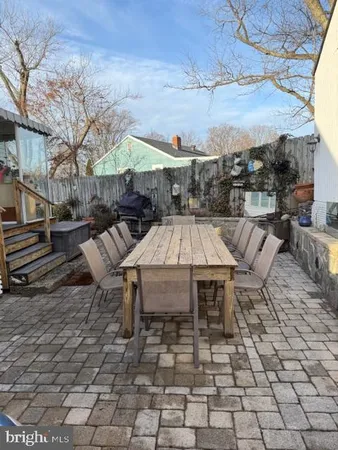a view of a patio with a table and chairs