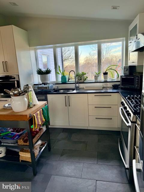 2511 Lindell Street Silver Spring, MD 20902 - Photo 8 of 21 a kitchen with stainless steel appliances a stove and a sink