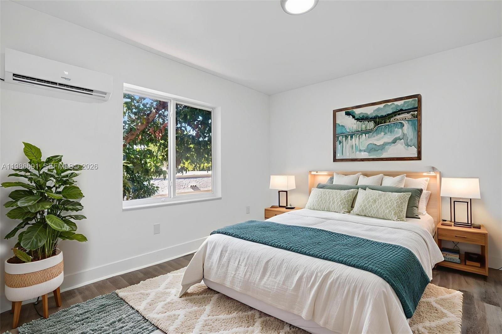 1630 Southwest 10th Street, Unit 1 Miami, FL 33135 - Photo 7 of 10 a bedroom with a bed potted plant and a window