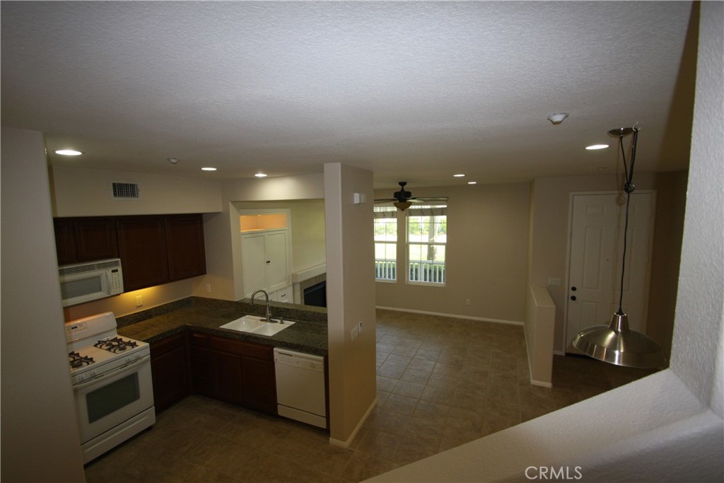11 Rumford Street Ladera Ranch, CA 92694 - Photo 11 of 24 a kitchen with granite countertop a sink and a stove top oven