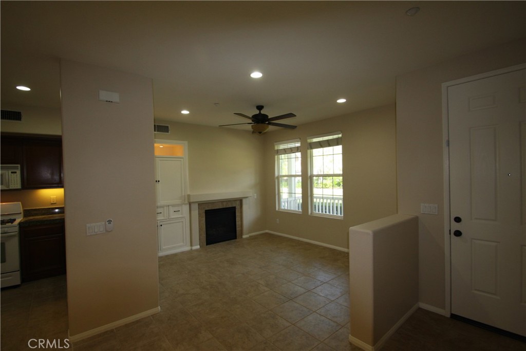 11 Rumford Street Ladera Ranch, CA 92694 - Photo 3 of 24 a view of an empty room with a fireplace and a window
