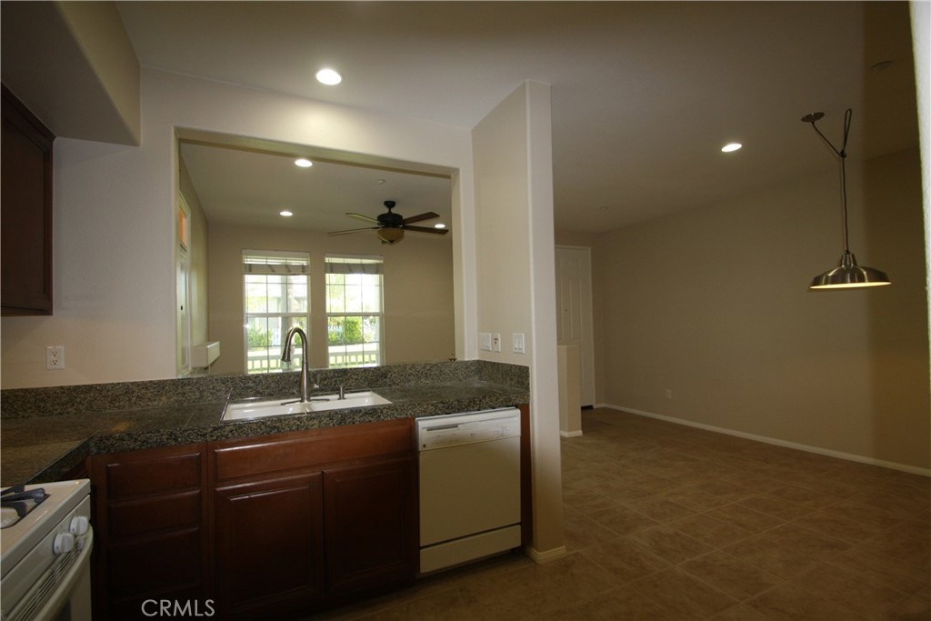 11 Rumford Street Ladera Ranch, CA 92694 - Photo 10 of 24 a bathroom with a granite countertop sink a mirror and a toilet