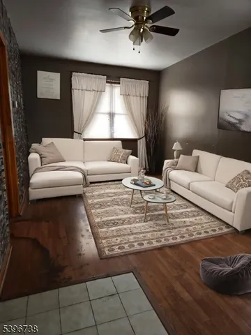 a living room with furniture and a lamp