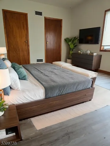 a bedroom with a bed and a television