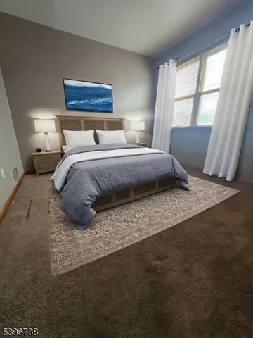 a bedroom with a large bed and wooden floor