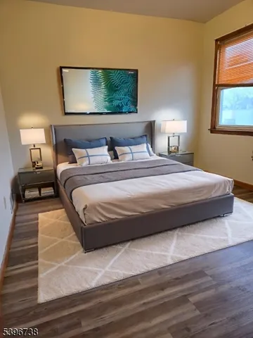 a bedroom with a bed and a night stand