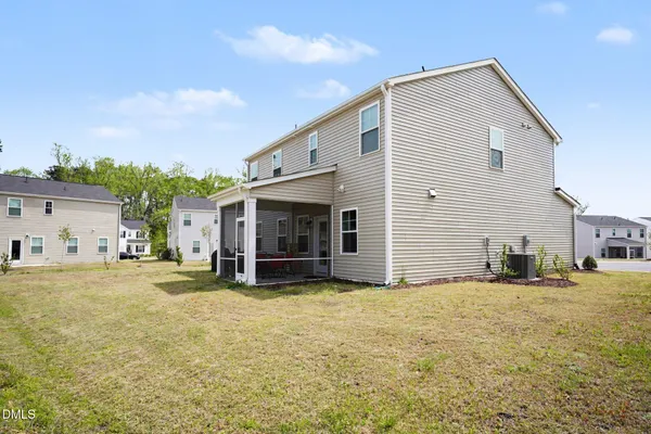 a view of a house with a yard and sitting area