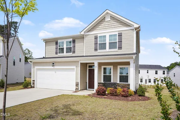 a front view of a house with a yard and garage