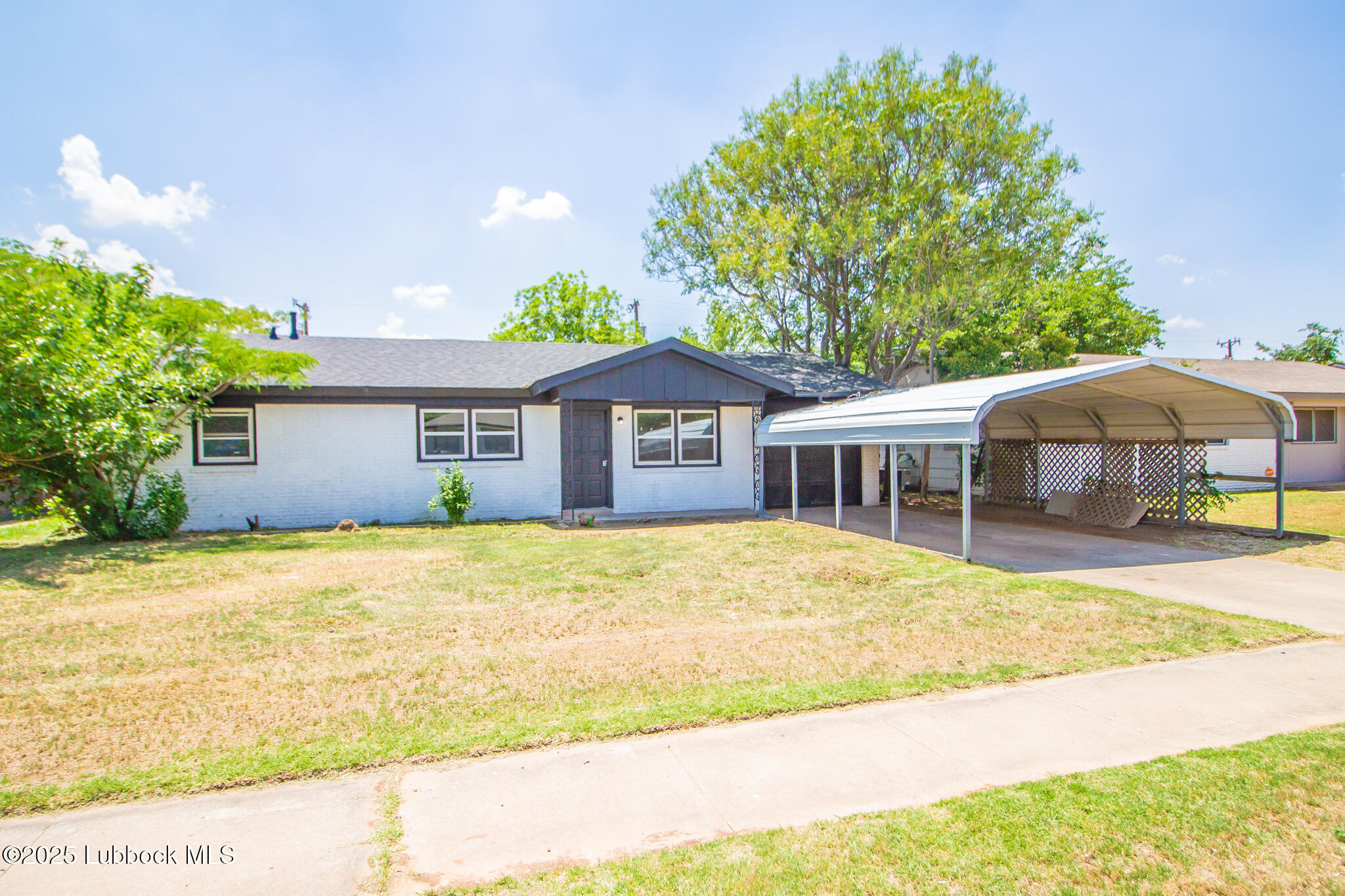 a front view of a house with a garden and patio