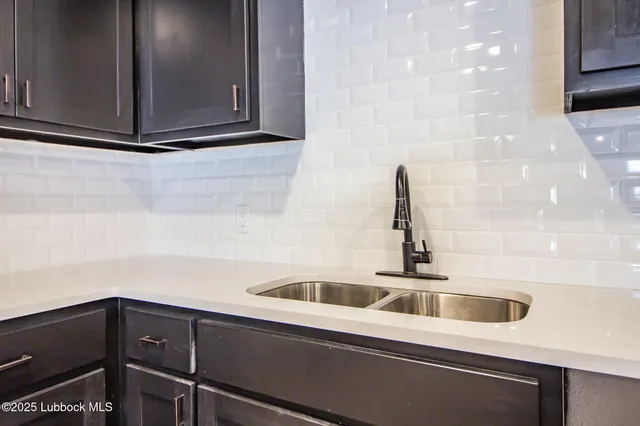 a kitchen with a sink and cabinets