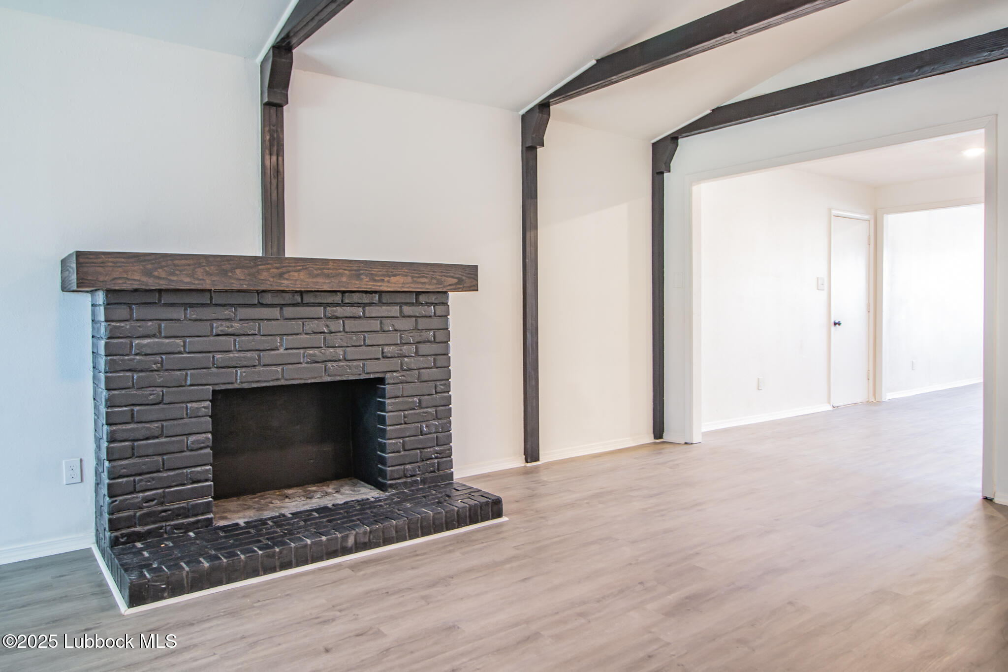 5313 39th Street Lubbock, TX 79414 - Photo 15 of 30 a living room with a fireplace and a rug
