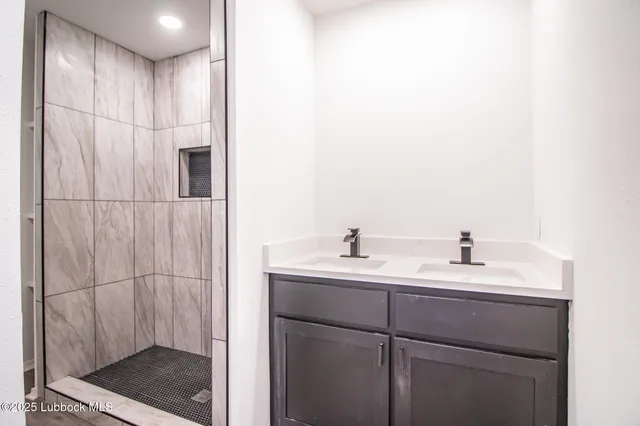 a bathroom with a double vanity sink and mirror