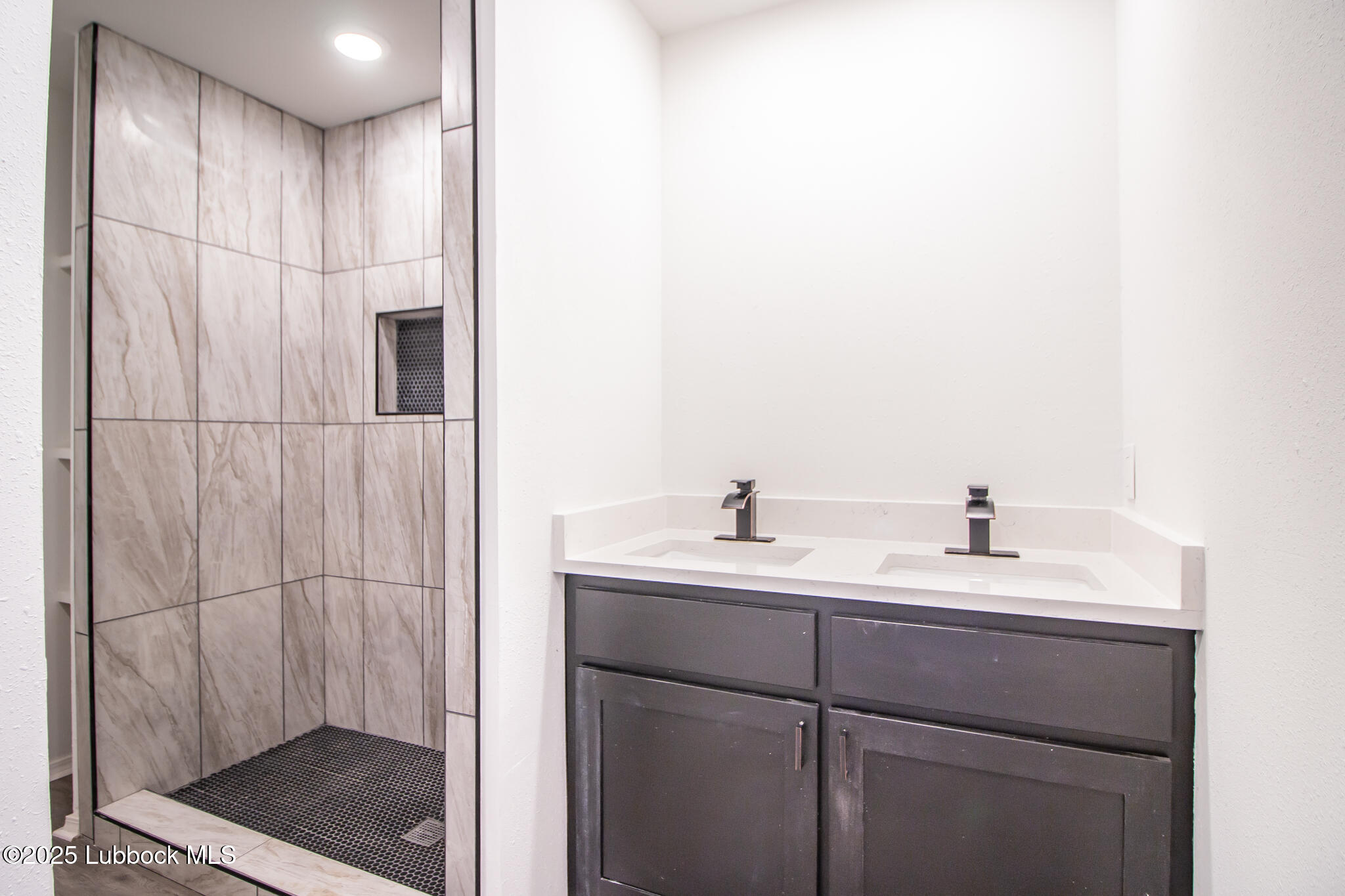 5313 39th Street Lubbock, TX 79414 - Photo 17 of 30 a bathroom with a double vanity sink and mirror