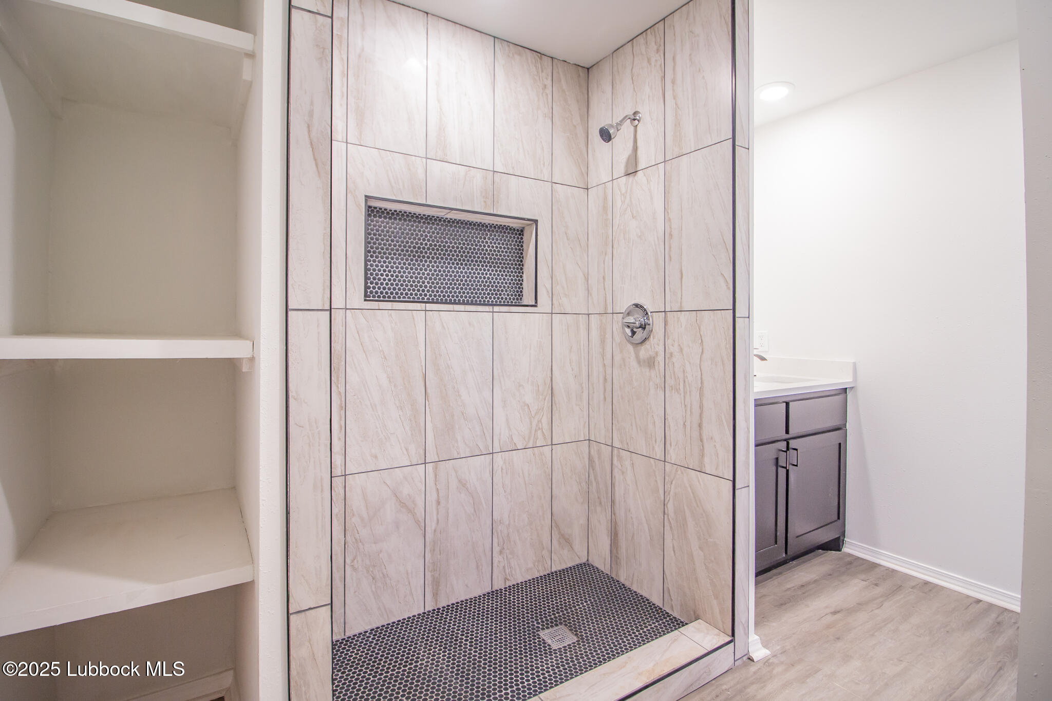 5313 39th Street Lubbock, TX 79414 - Photo 18 of 30 a bathroom with a shower and a glass door