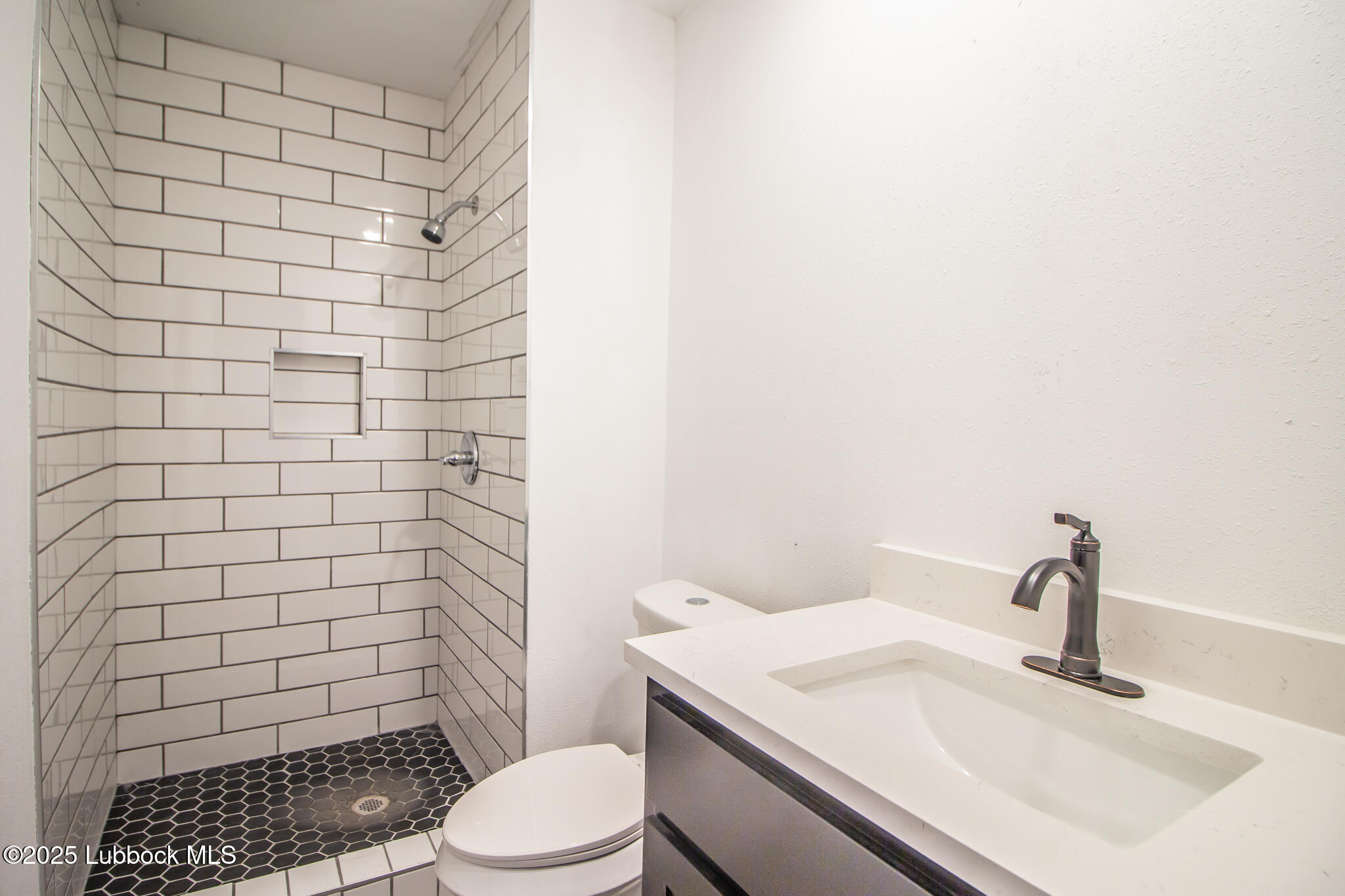 5313 39th Street Lubbock, TX 79414 - Photo 20 of 30 a bathroom with a sink a toilet and shower