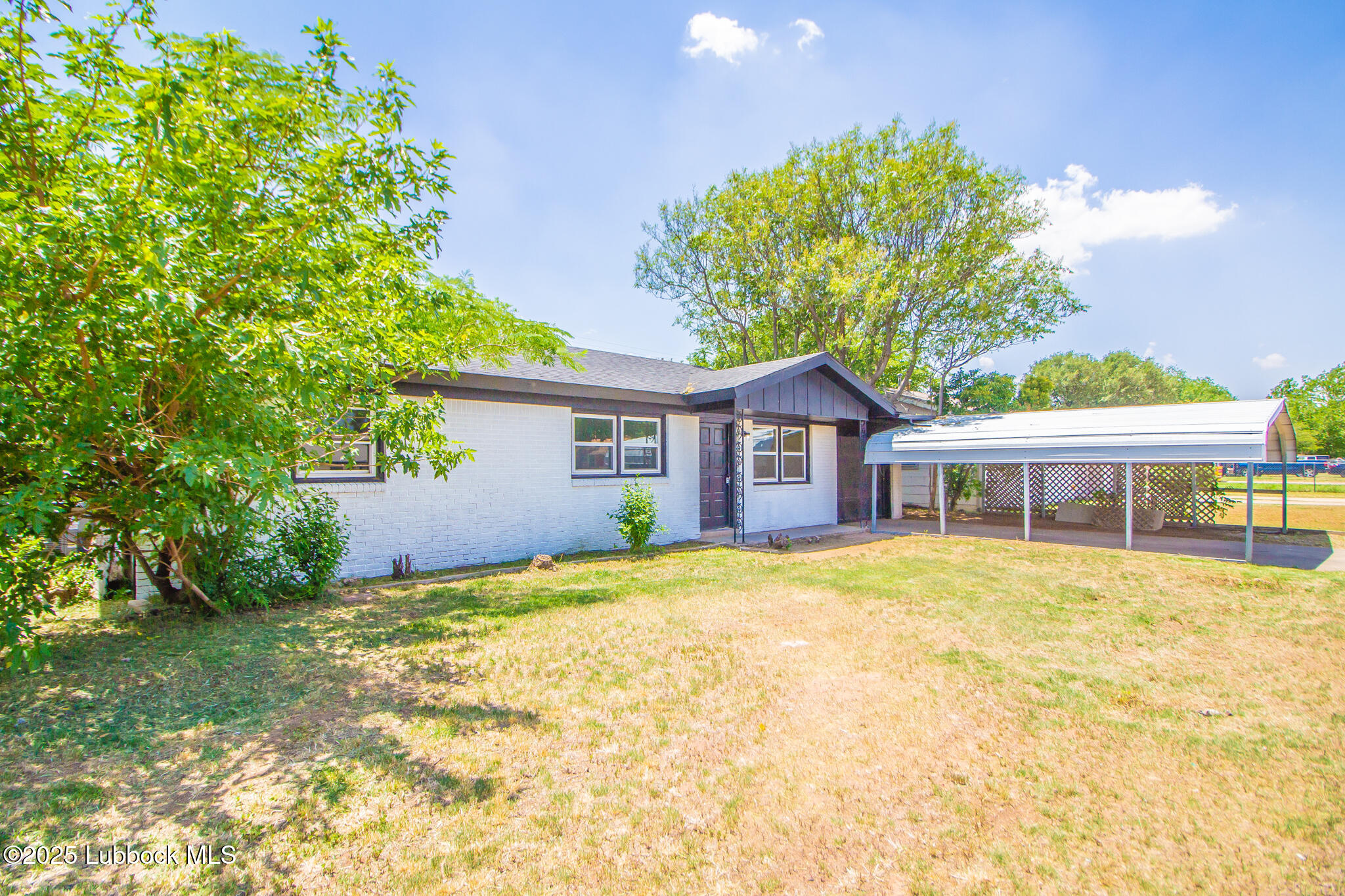 5313 39th Street Lubbock, TX 79414 - Photo 2 of 30 a front view of a house with a garden
