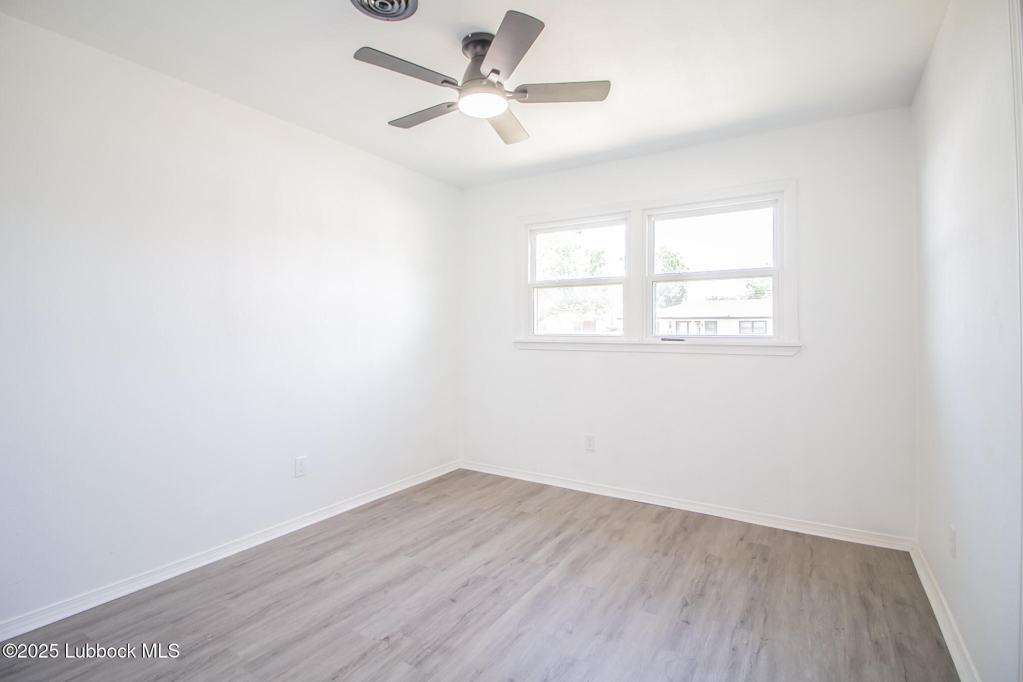 5313 39th Street Lubbock, TX 79414 - Photo 21 of 30 an empty room with a window and a fan
