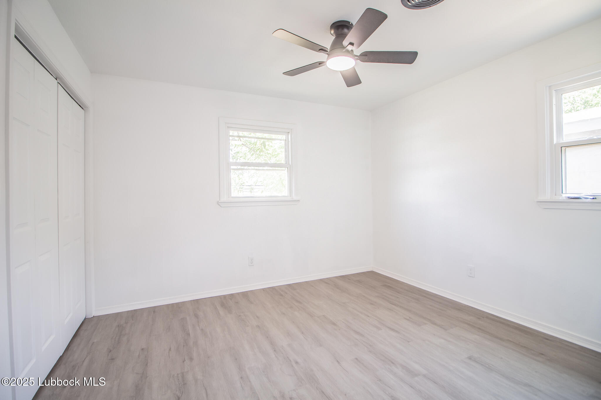 5313 39th Street Lubbock, TX 79414 - Photo 22 of 30 an empty room with a window and a ceiling fan