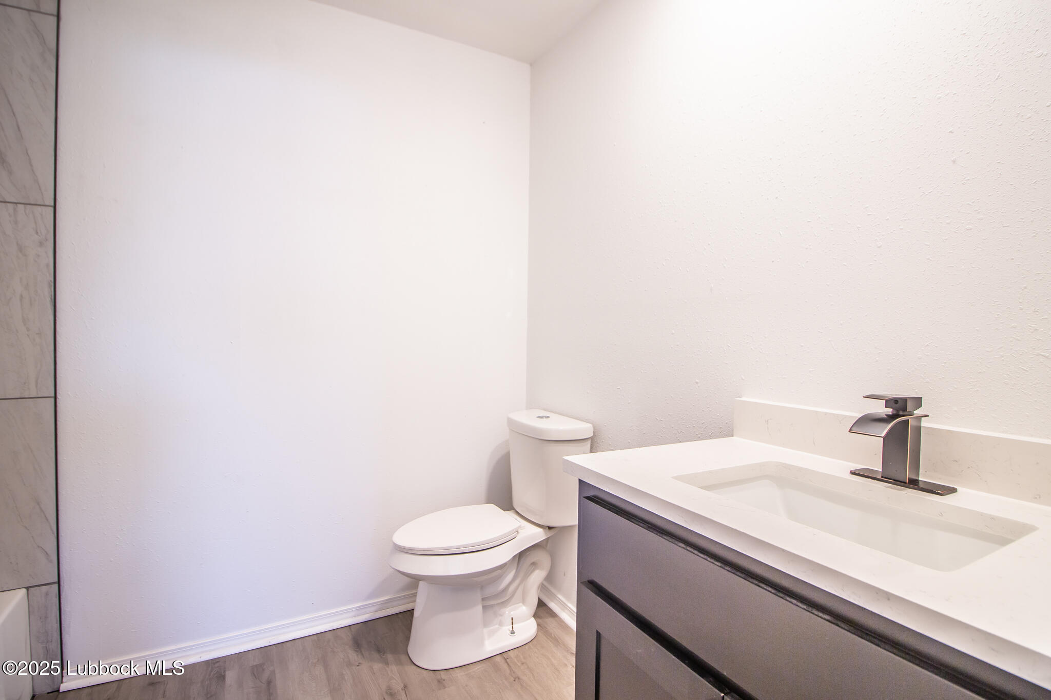 5313 39th Street Lubbock, TX 79414 - Photo 23 of 30 a bathroom with a sink and a toilet