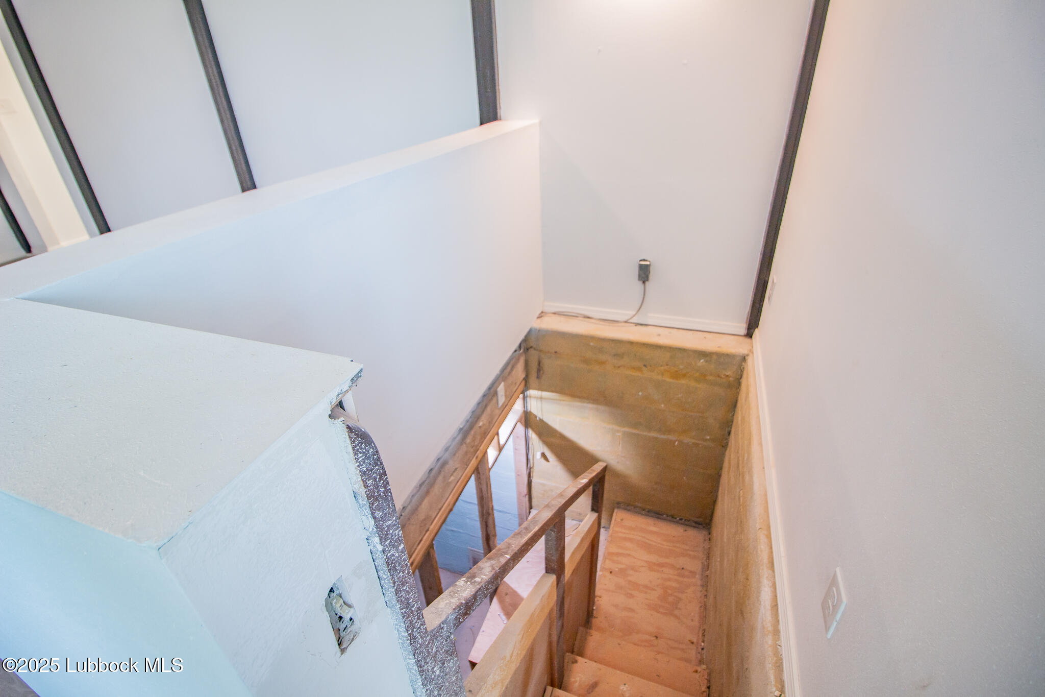 5313 39th Street Lubbock, TX 79414 - Photo 25 of 30 a view of staircase with railing and white walls