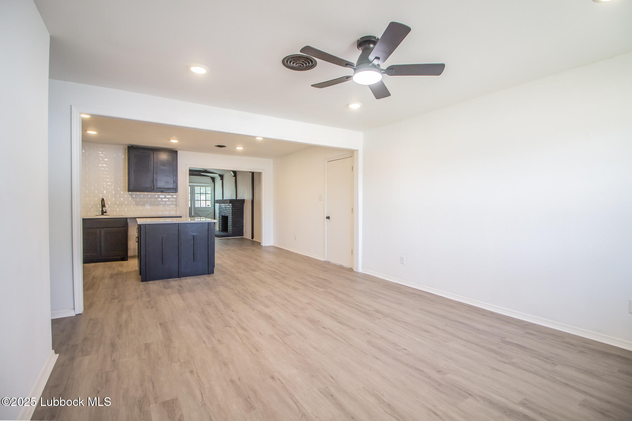 5313 39th Street Lubbock, TX 79414 - Photo 8 of 30 a view of a kitchen with a sink and a cabinet wooden floor