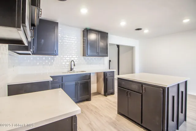 a kitchen with a sink and a refrigerator