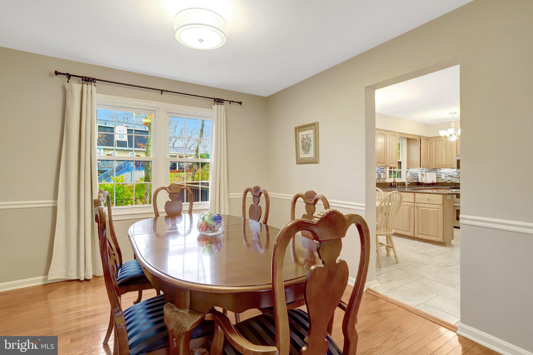 8705 Side Saddle Road Springfield, VA 22152 - Photo 13 of 73 a view of a dining room with furniture and wooden floor