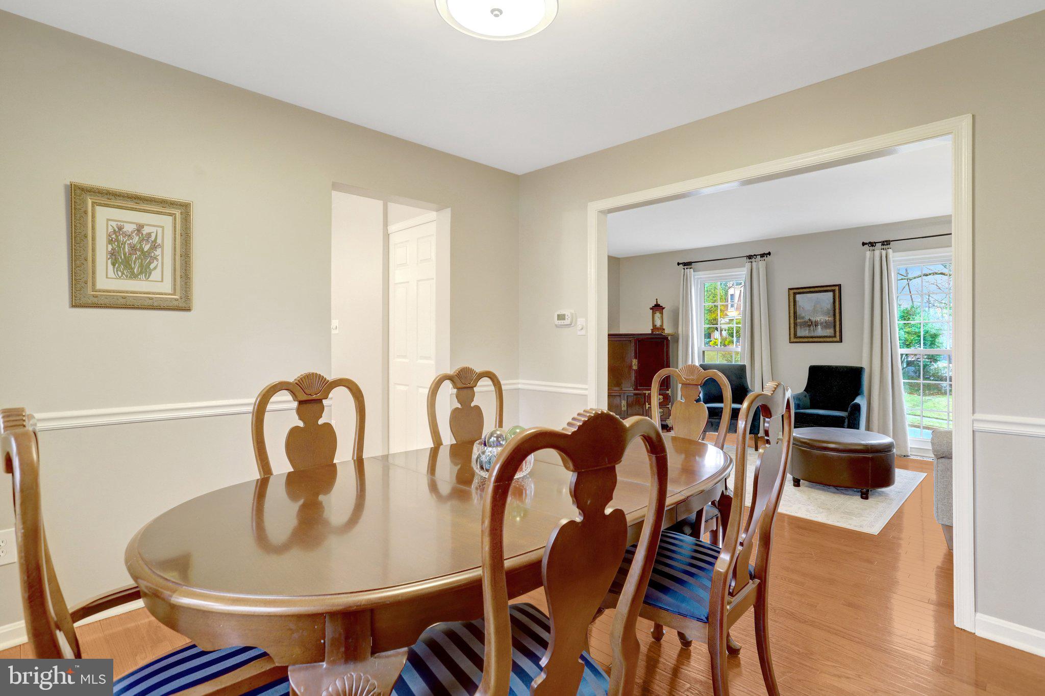8705 Side Saddle Road Springfield, VA 22152 - Photo 15 of 73 a view of a dining room with furniture and wooden floor