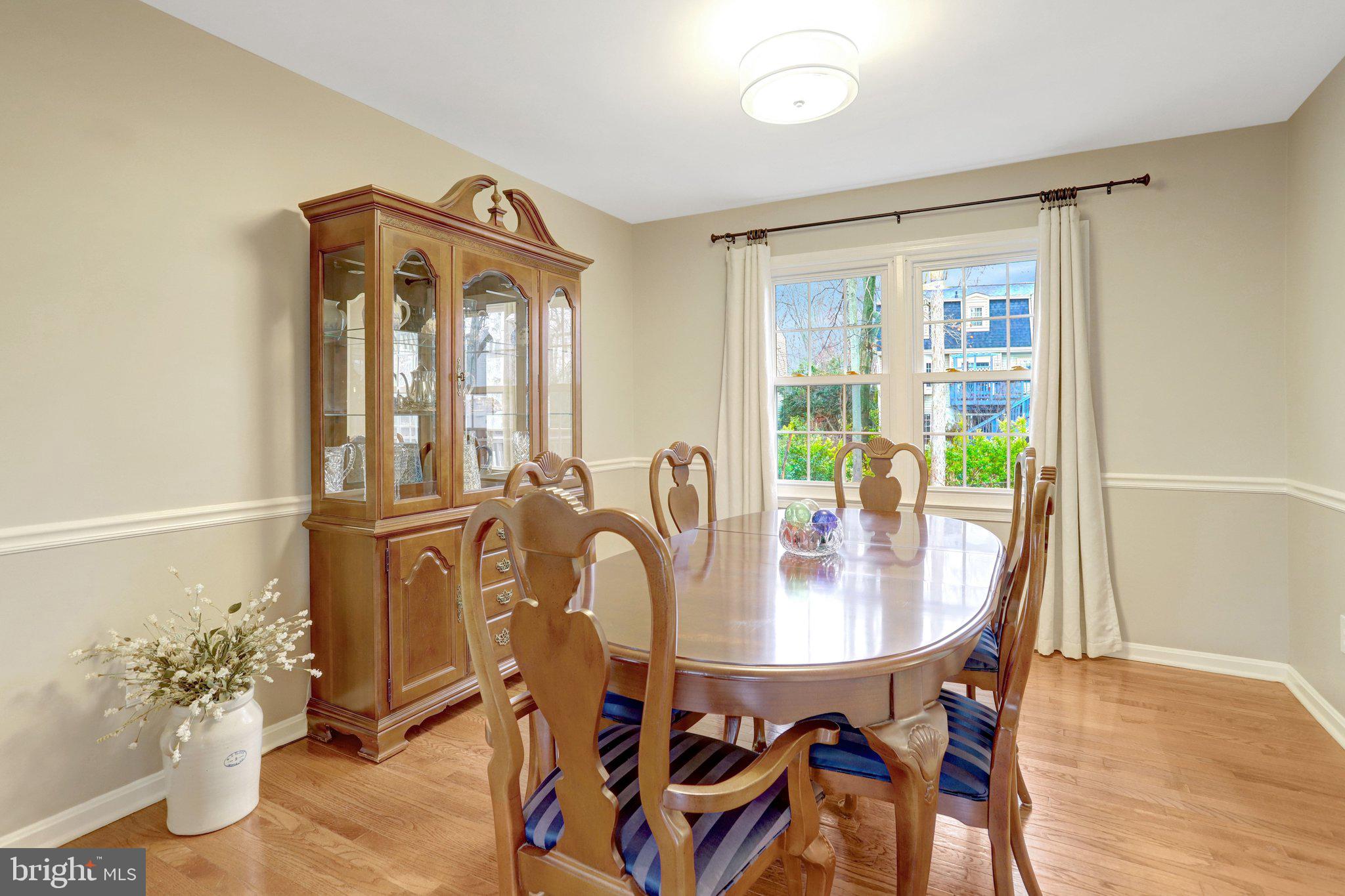 8705 Side Saddle Road Springfield, VA 22152 - Photo 16 of 73 a view of a dining room with furniture and wooden floor