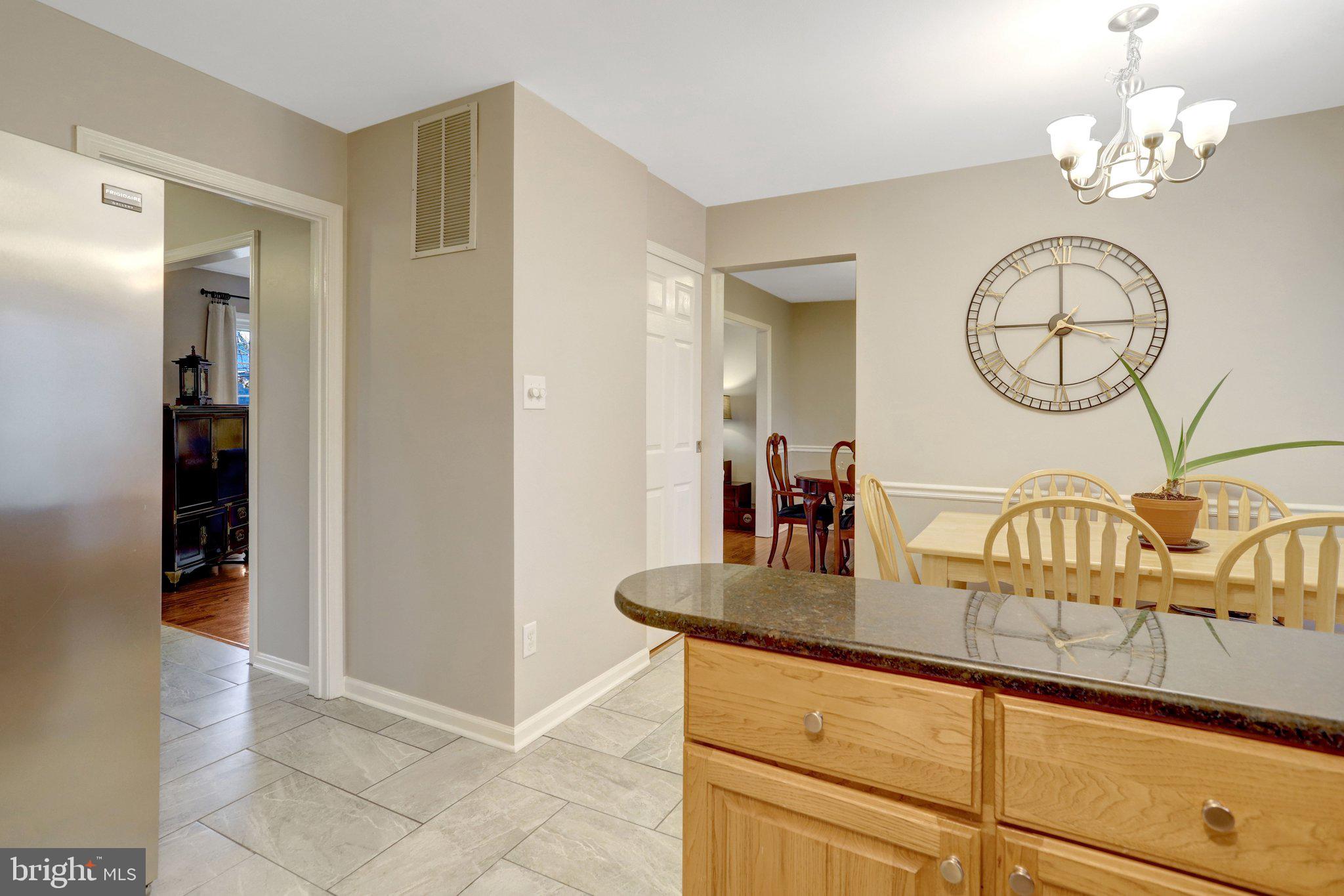 8705 Side Saddle Road Springfield, VA 22152 - Photo 17 of 73 a kitchen with stainless steel appliances granite countertop a sink and a refrigerator