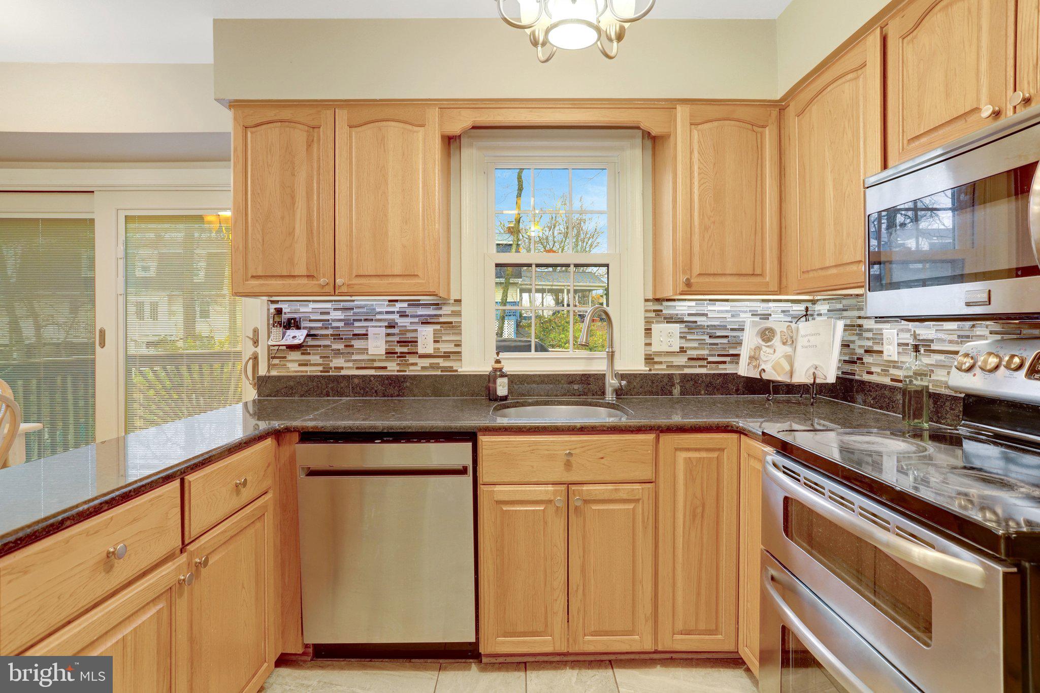8705 Side Saddle Road Springfield, VA 22152 - Photo 19 of 73 a kitchen with granite countertop a sink and a stove
