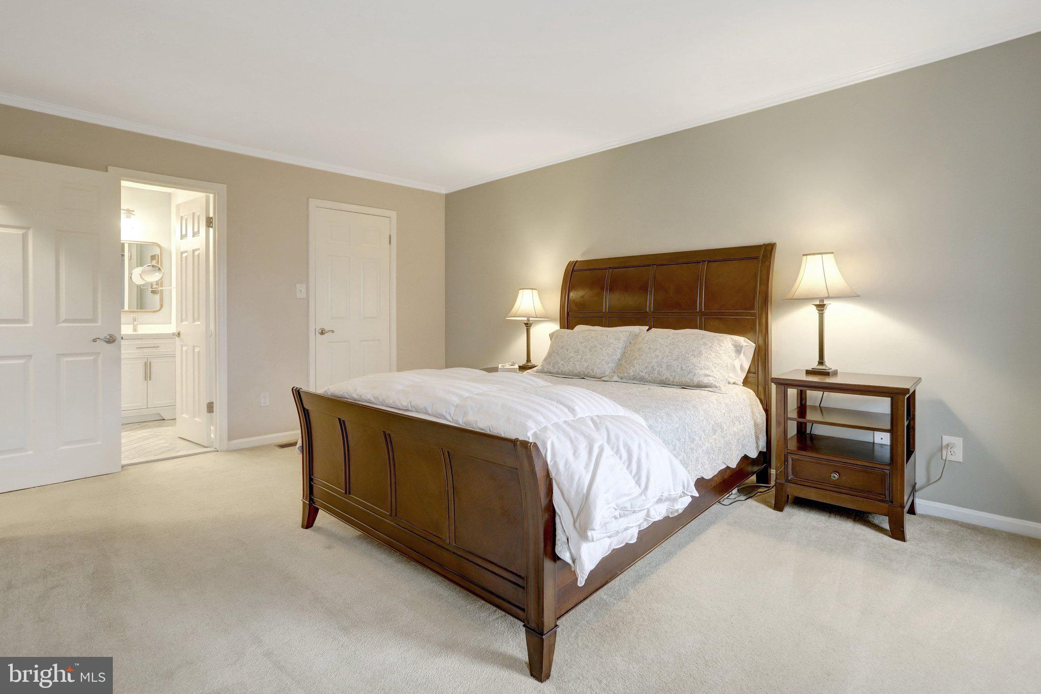 8705 Side Saddle Road Springfield, VA 22152 - Photo 31 of 73 a spacious bedroom with a bed and a cabinets