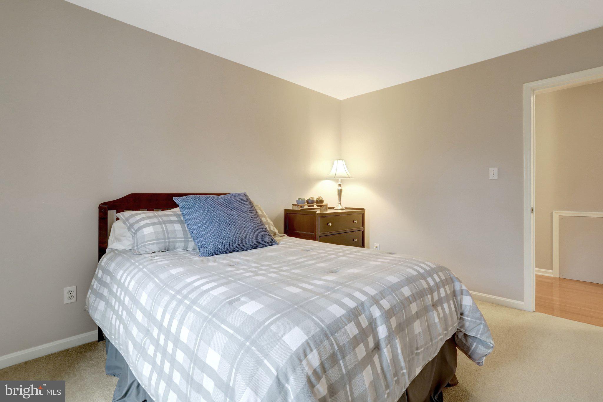 8705 Side Saddle Road Springfield, VA 22152 - Photo 36 of 73 a bedroom with a bed and a lamp