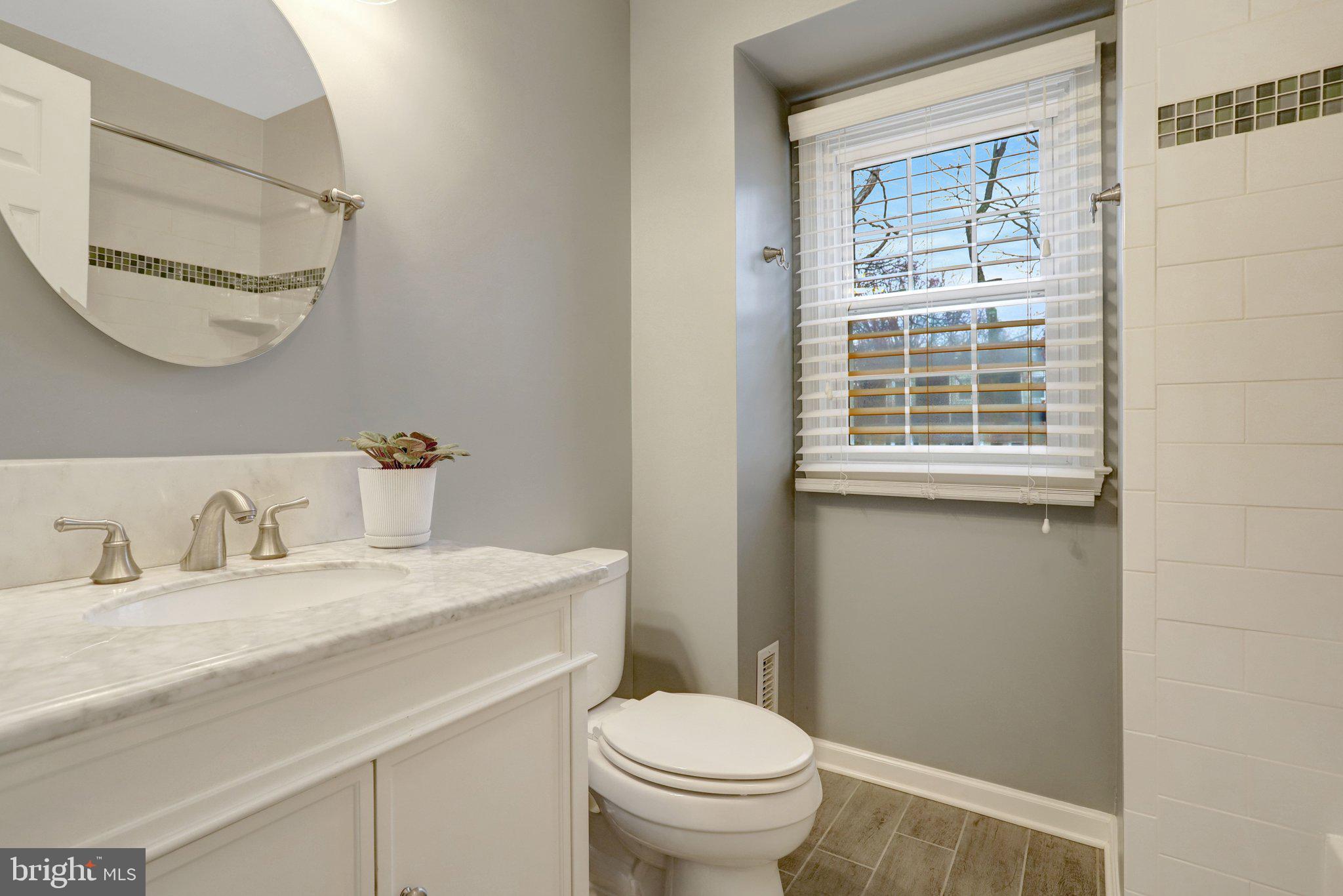 8705 Side Saddle Road Springfield, VA 22152 - Photo 48 of 73 a bathroom with a granite countertop sink mirror vanity and toilet