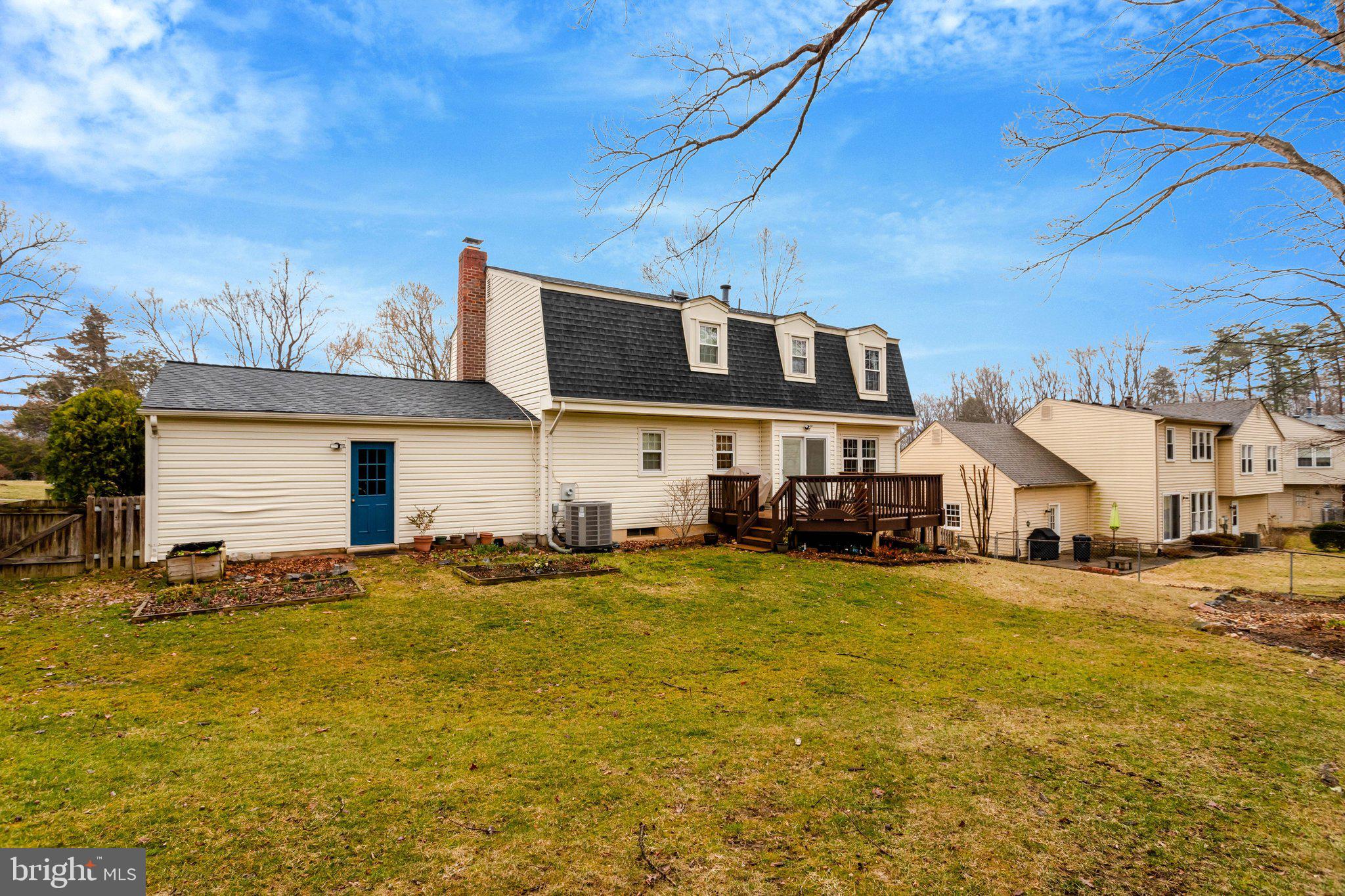 8705 Side Saddle Road Springfield, VA 22152 - Photo 69 of 73 a view of a big house with a patio and a yard