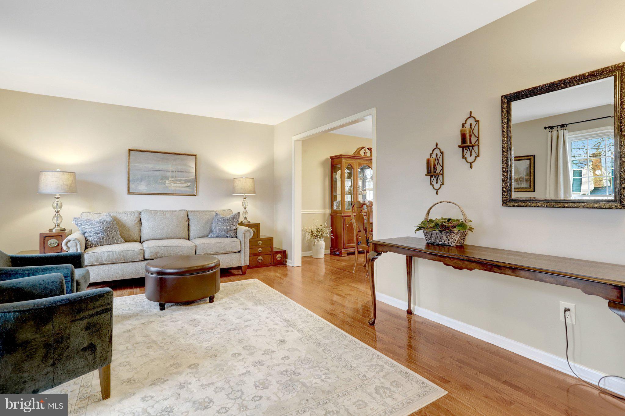 8705 Side Saddle Road Springfield, VA 22152 - Photo 10 of 73 a living room with furniture and paintings on the wall